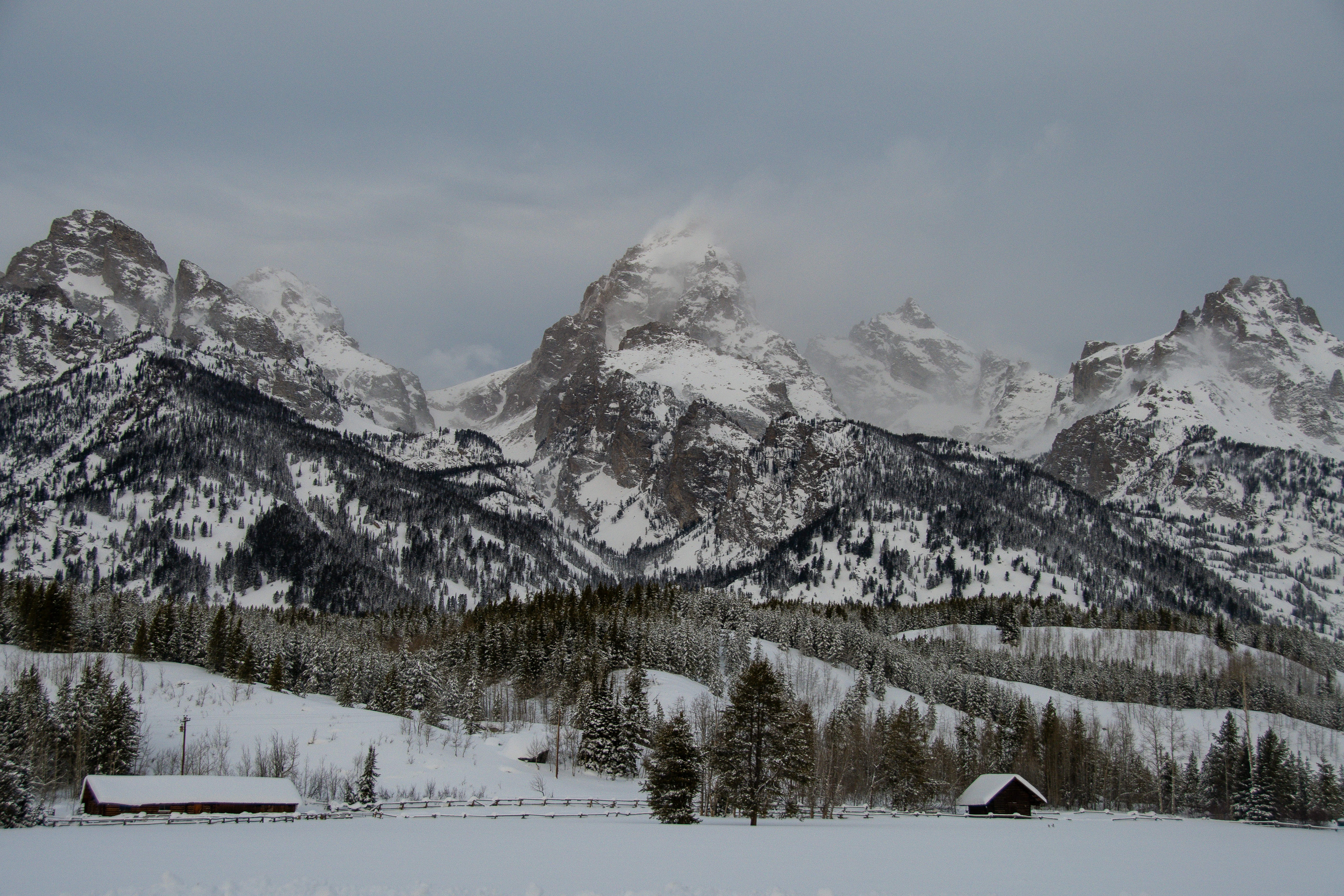 Winter view of the Teton mountain range beneath a cloudy sky